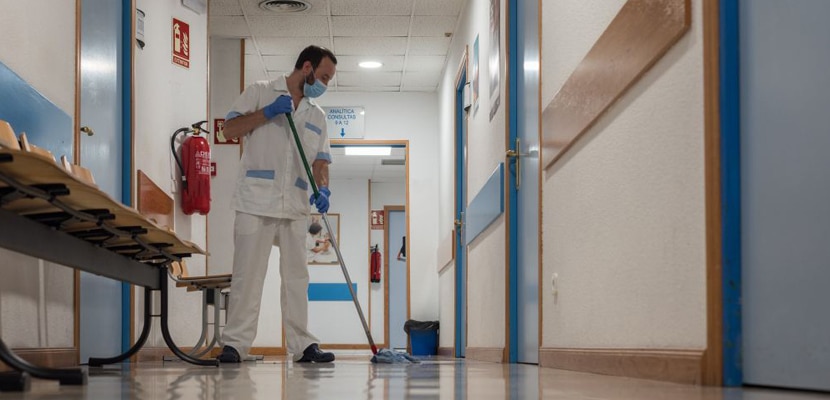 Trabajador masculino limpiando corredor de hospital